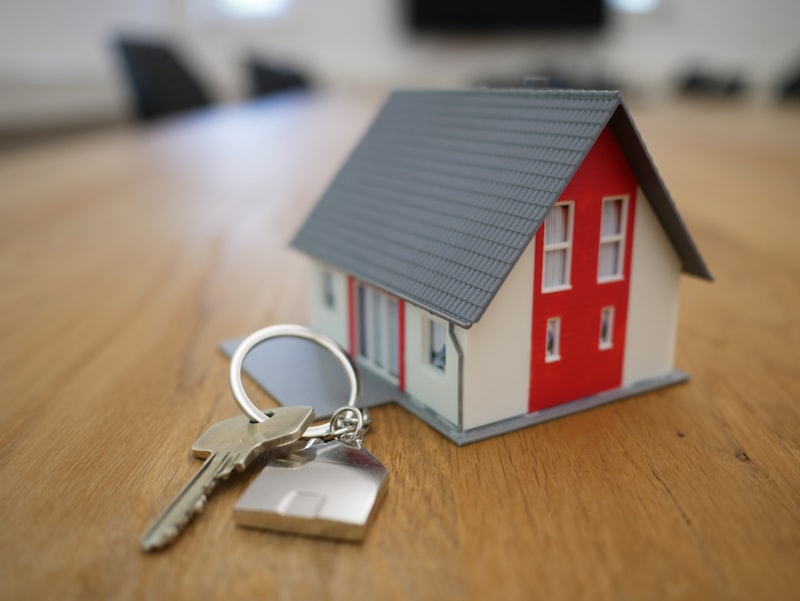Young couple receiving house keys from estate agent, first time home buyers in Northern Ireland