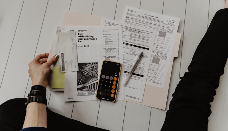 Person reviewing mortgage documents and financial paperwork for remortgage